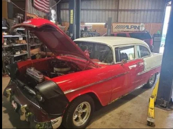 Red and white 1955 Chevy Bel Air with the hood open