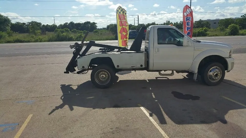 The shop's white Ford wrecker parked on Hwy 146