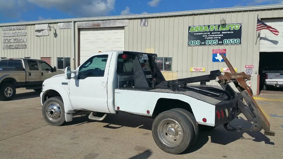 Area 51 Auto storefront on Highway 146 North with the green sign and wrecker